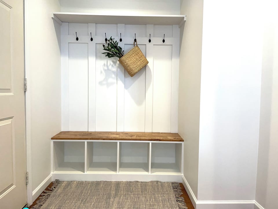 Welcome to our home. Settle in with custom cabinetry and built-in coat racks.