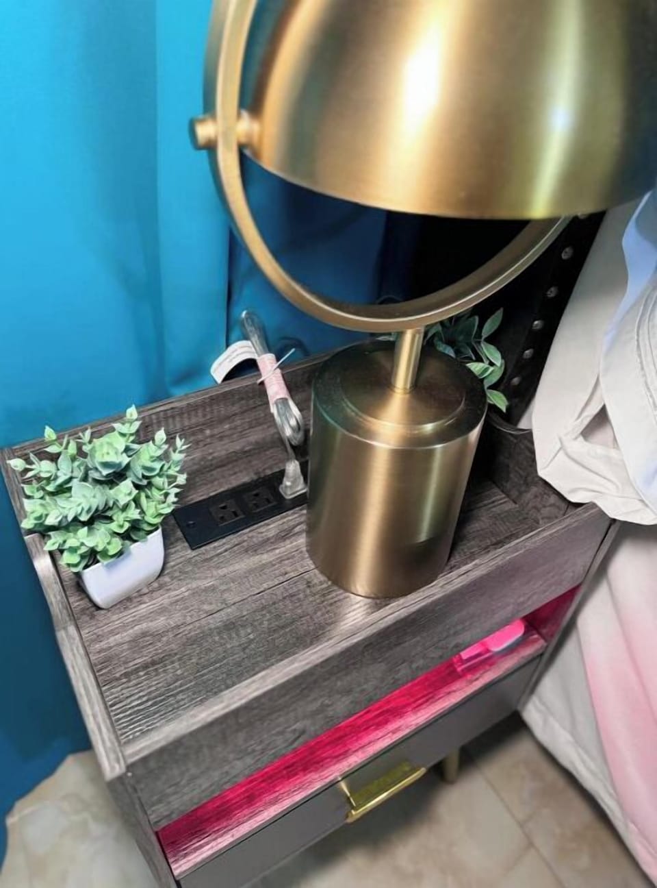 Nightstand with a lamp and built-in charging ports.
