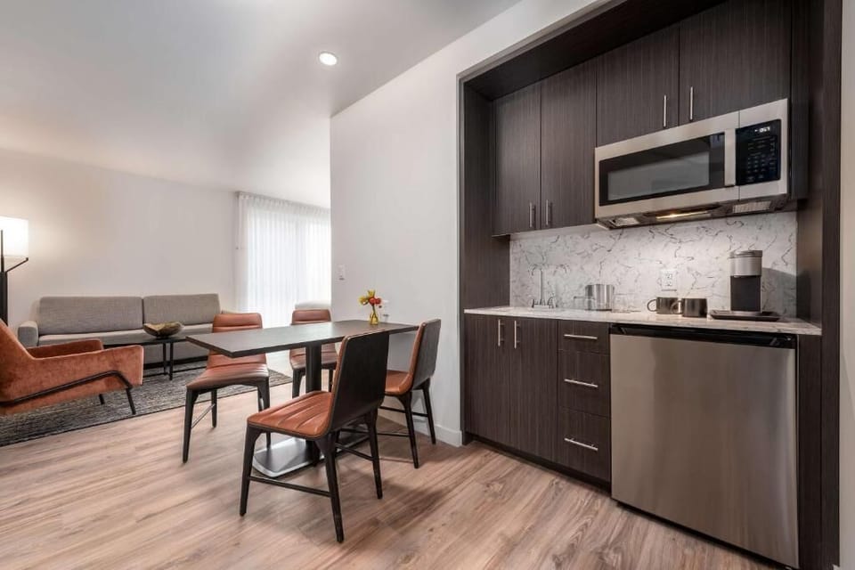 Gather for meals with a sleek kitchenette and cozy seating.
