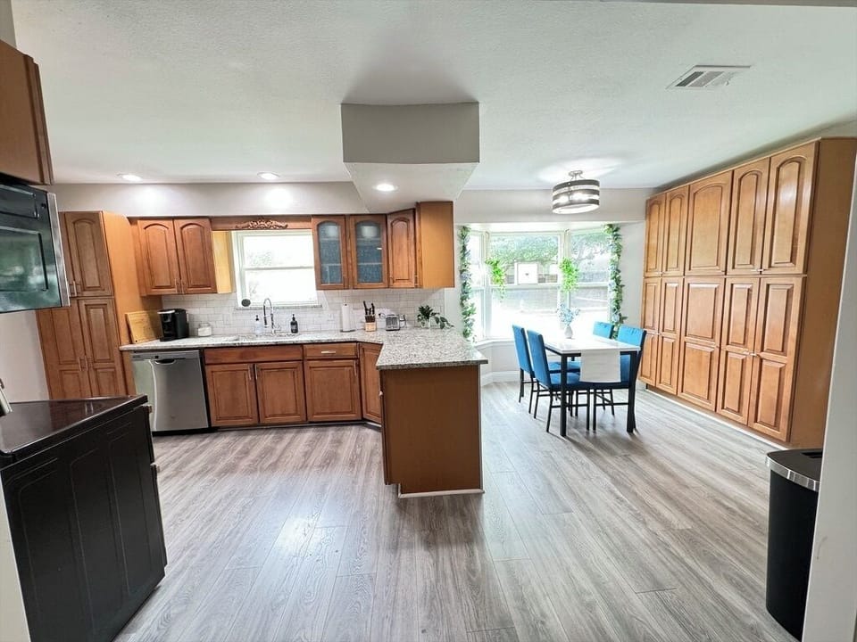 Spacious kitchen equipped with parquet floors and ample cupboards