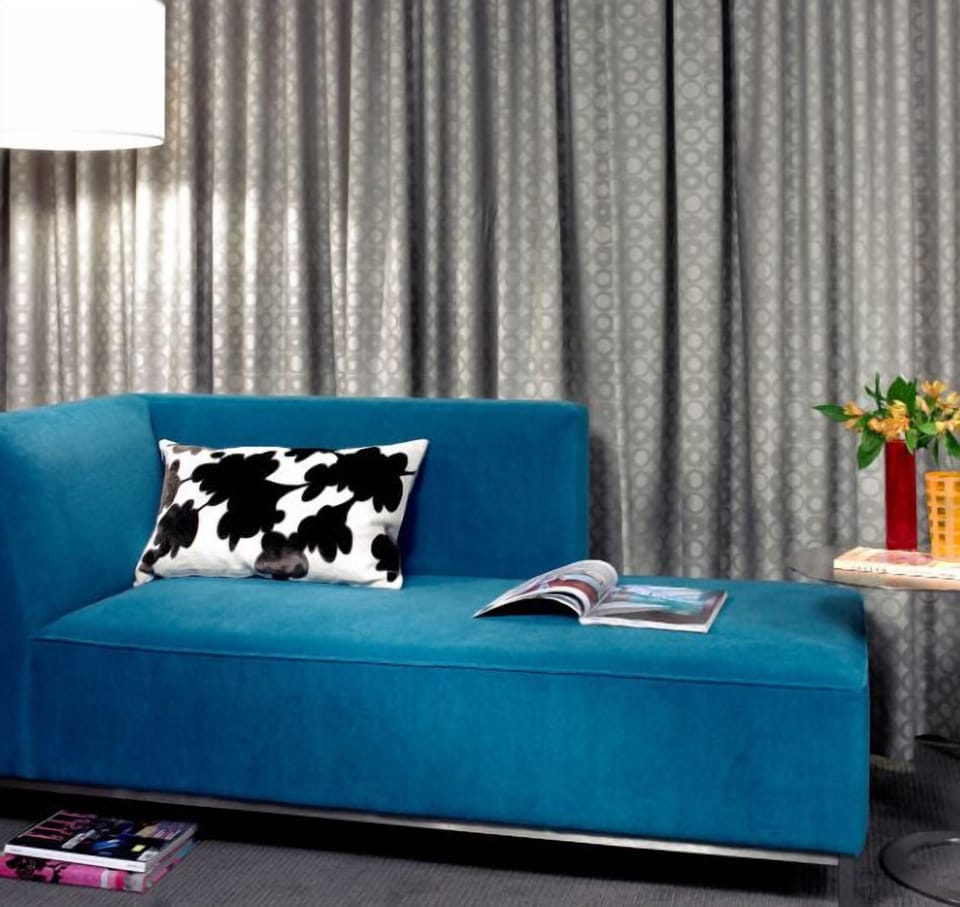 Stylish lounge area with a striking blue sofa and modern decor, providing a vibrant space to relax or entertain.