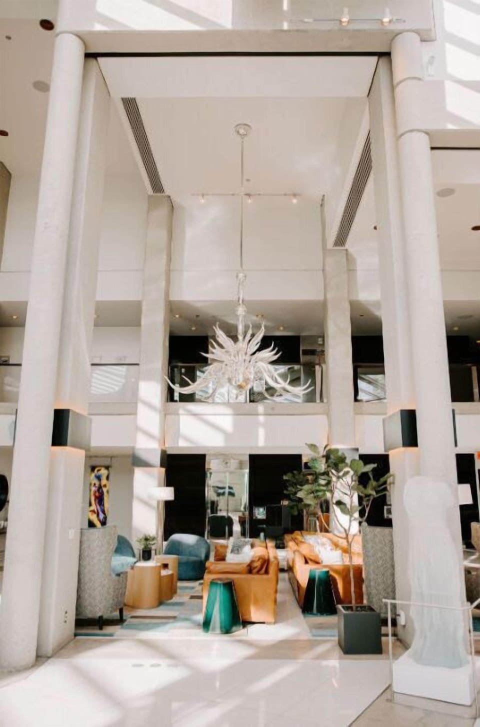 A unique perspective of the front desk area, emphasizing the striking architectural details and contemporary style of the hotel.