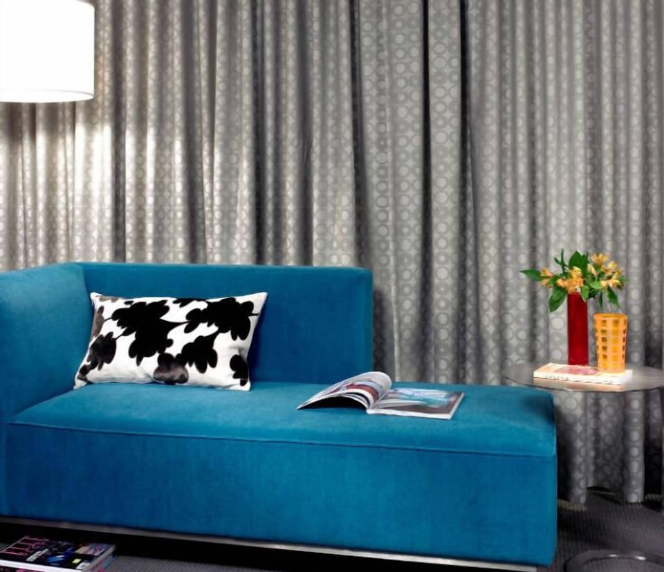 Stylish lounge area with a vibrant sofa and chic decor, perfect for relaxation or catching up on your favorite reads.