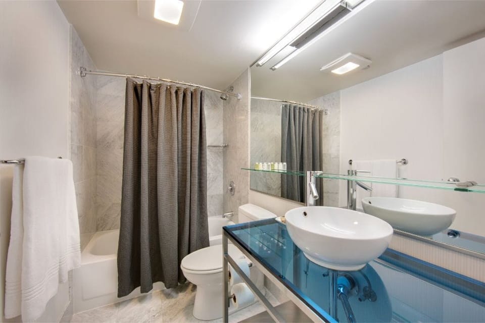 Sophisticated and clean bathroom design, featuring marble details and neutral tones, ensuring a refreshing start or end to your day.