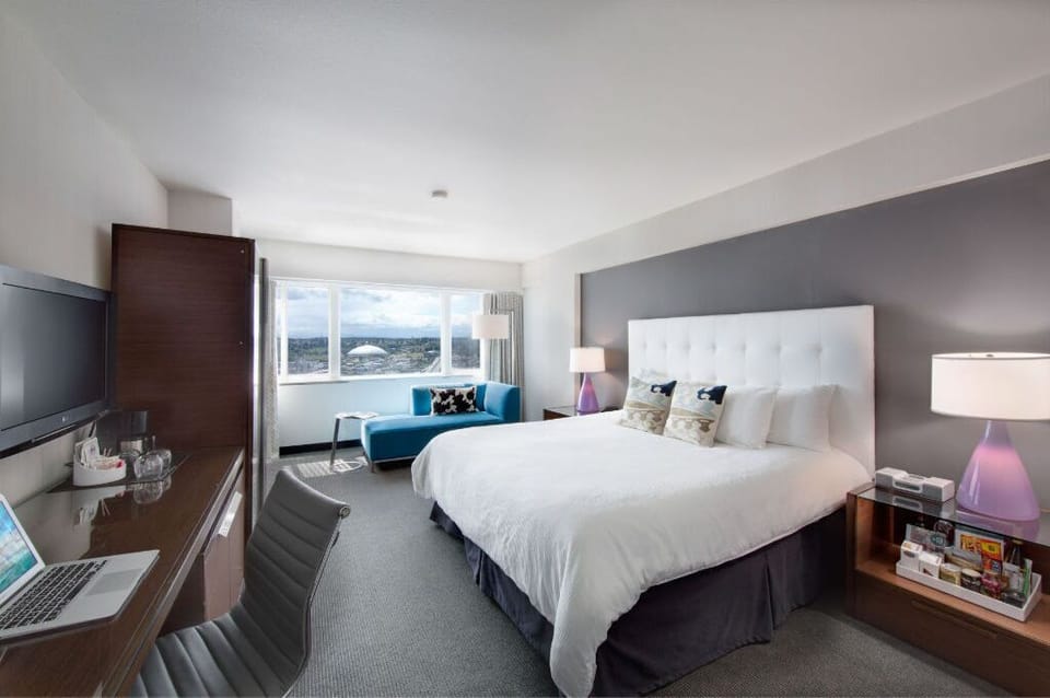 Luxuriously appointed bedroom with a plush, tufted headboard and high-quality linens, ensuring a stylish and restful night's sleep.