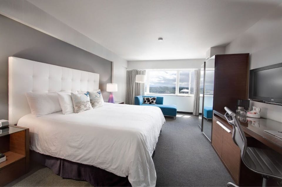 Enjoy the expansive feel of this inviting bedroom, complete with comfortable, bold furniture and ample space to unwind.