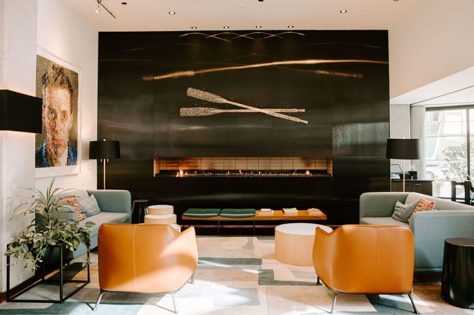 A cozy yet elegant lounge area, highlighted by its striking fireplace and chic furnishings.