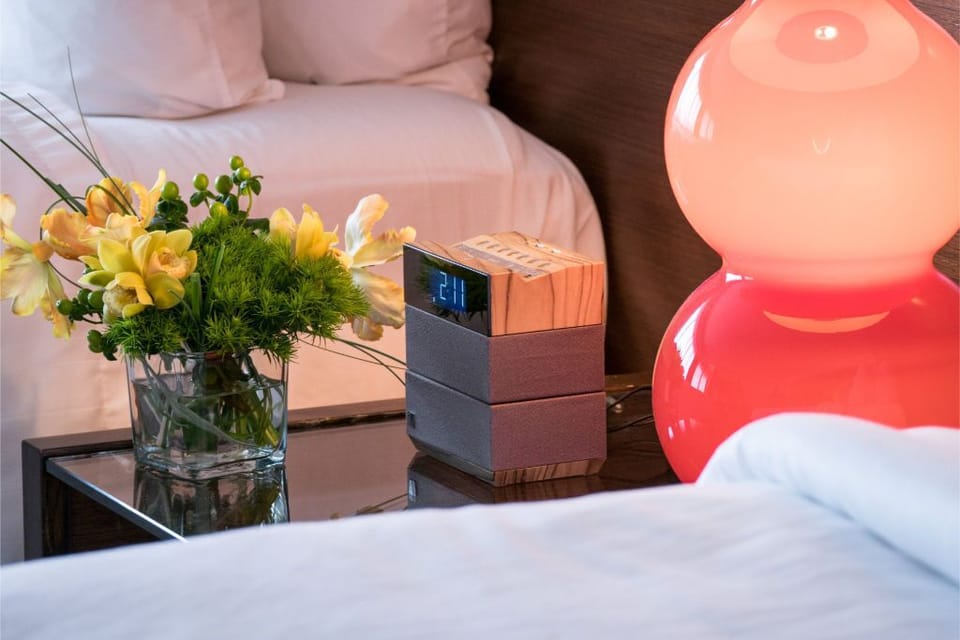 Elegant bedside setting featuring fresh flowers and stylish decor, adding a personal touch to enhance your relaxation.