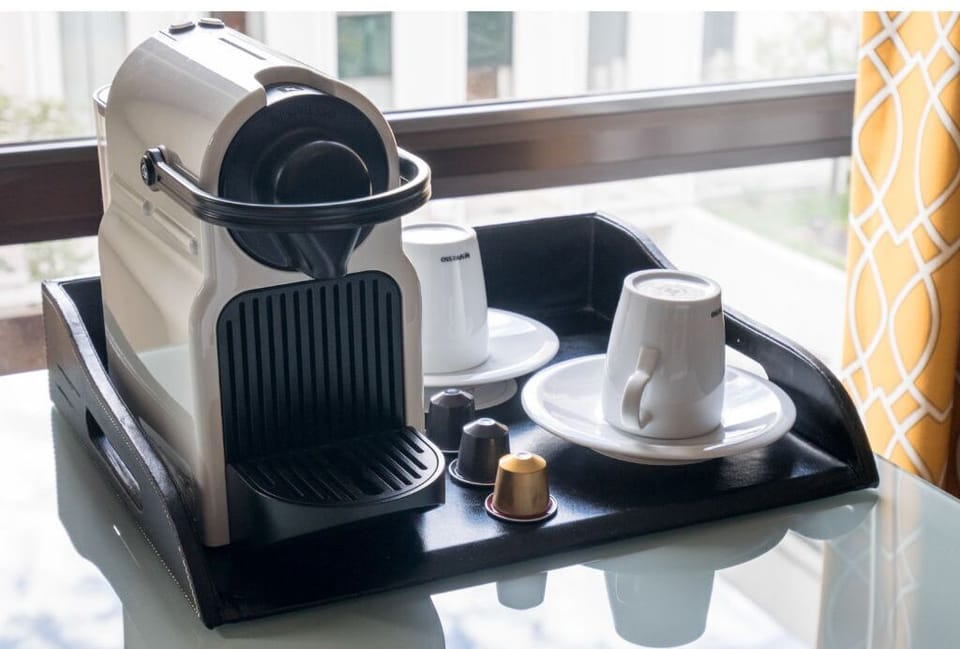 Enjoy your morning coffee with our convenient in-room coffee maker, set in a sleek and stylish area.