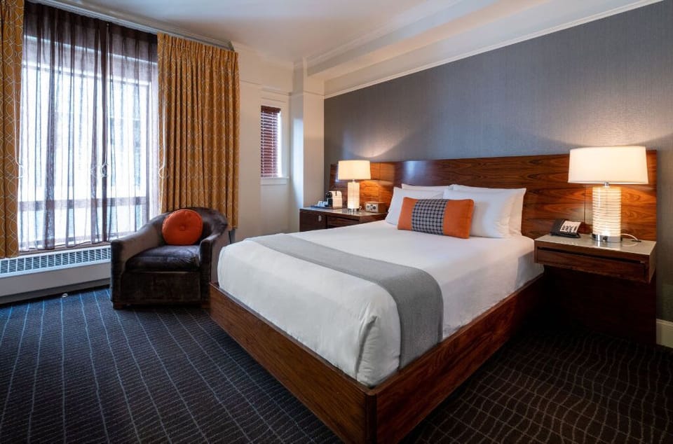 Comfortable Queen room featuring a plush bed, modern amenities, and a cozy work area.