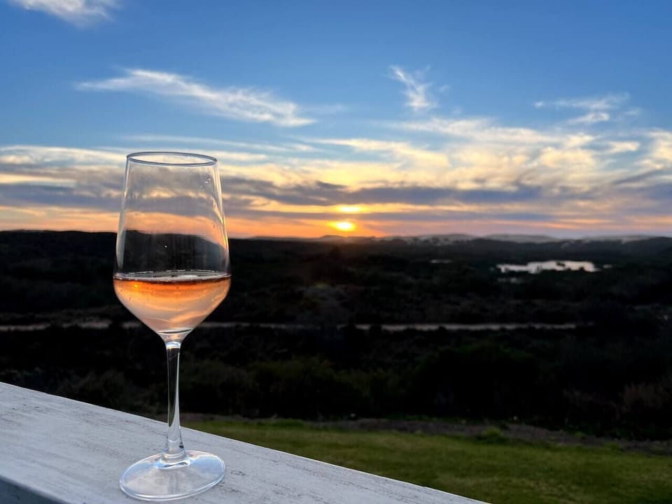 Sunsets & local wines  - does it get any better?  Lake front view from the back porch of the Cottage - Total Bliss ❤️