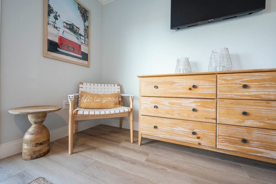 Warm vibes with wooden decor, cozy pillows, and charming wall art.