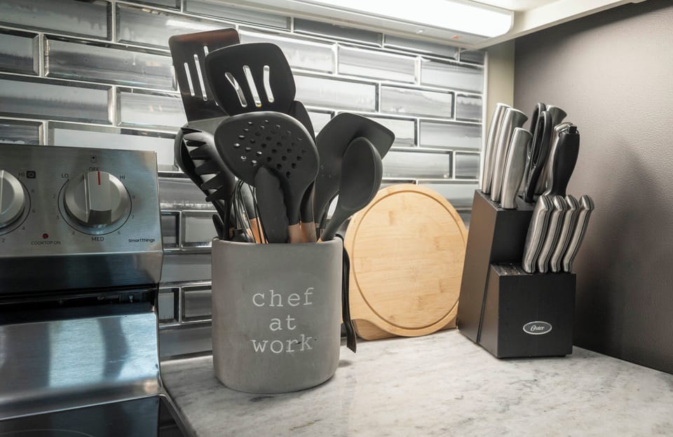 Chic kitchen corner with sleek utensils, knife set, and modern backsplash.