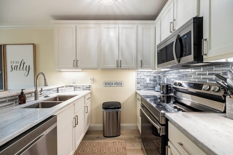 Bright coastal kitchen with modern touches, stainless steel, and beachy vibes.