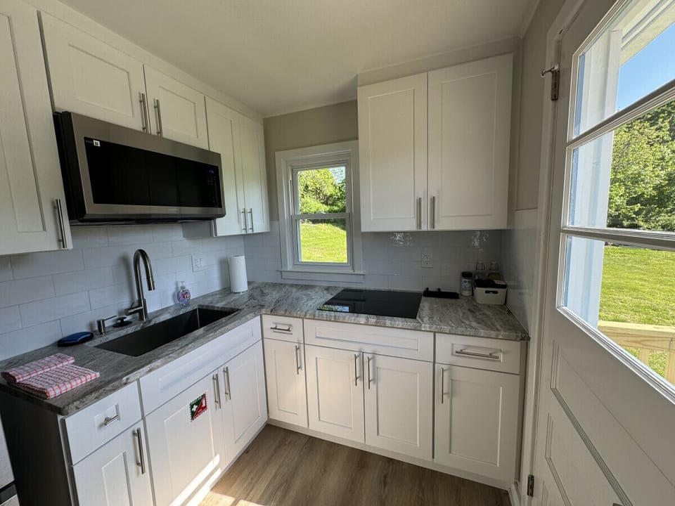 Small space, big convenience! Our modern kitchenette is fully equipped with a microwave, mini-fridge, and all the essential cookware for a quick and easy meal