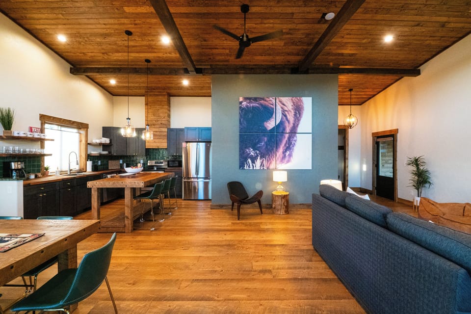 View of cabin's kitchen, reading nook, great room, and entry.