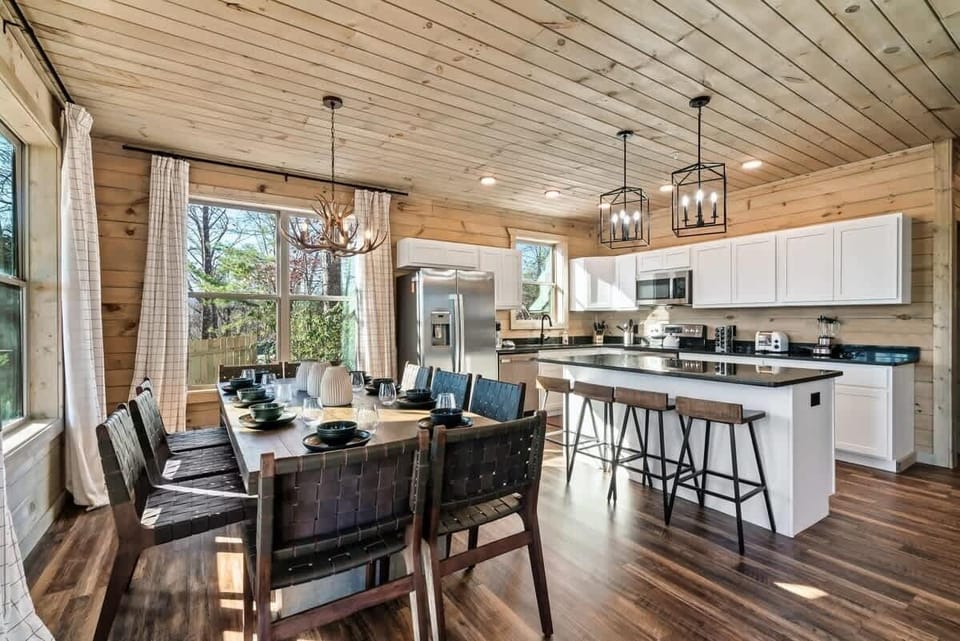 Gather around the stylish table, surrounded by natural light and rustic charm!