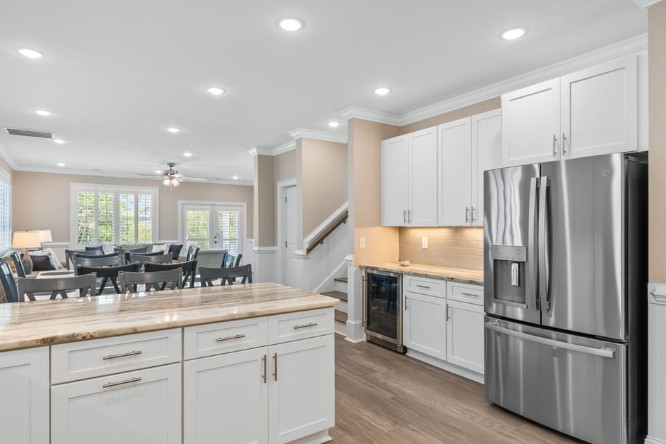 Your fully equipped kitchen features white cabinetry, granite counters, and stainless steel appliances, perfect for preparing home-cooked meals.
