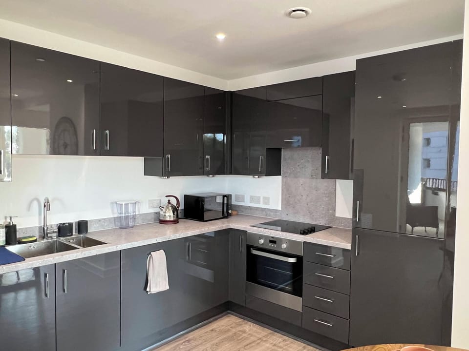 Fully stocked kitchen with pans and utensils, appliances, tea and coffee