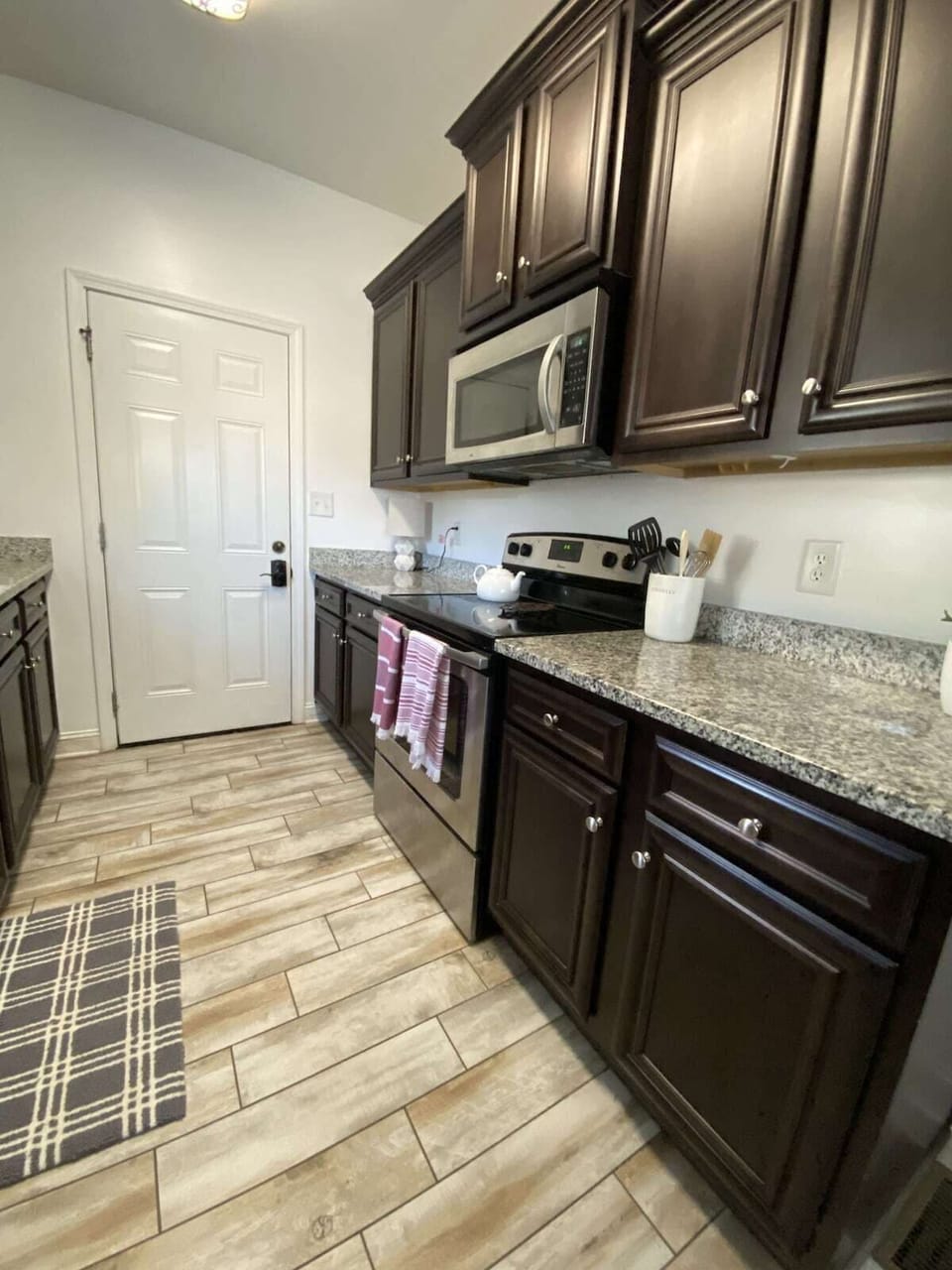 2nd view of kitchen and main entry door.