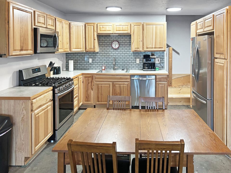 Full kitchen utensils with stainless steel appliances.