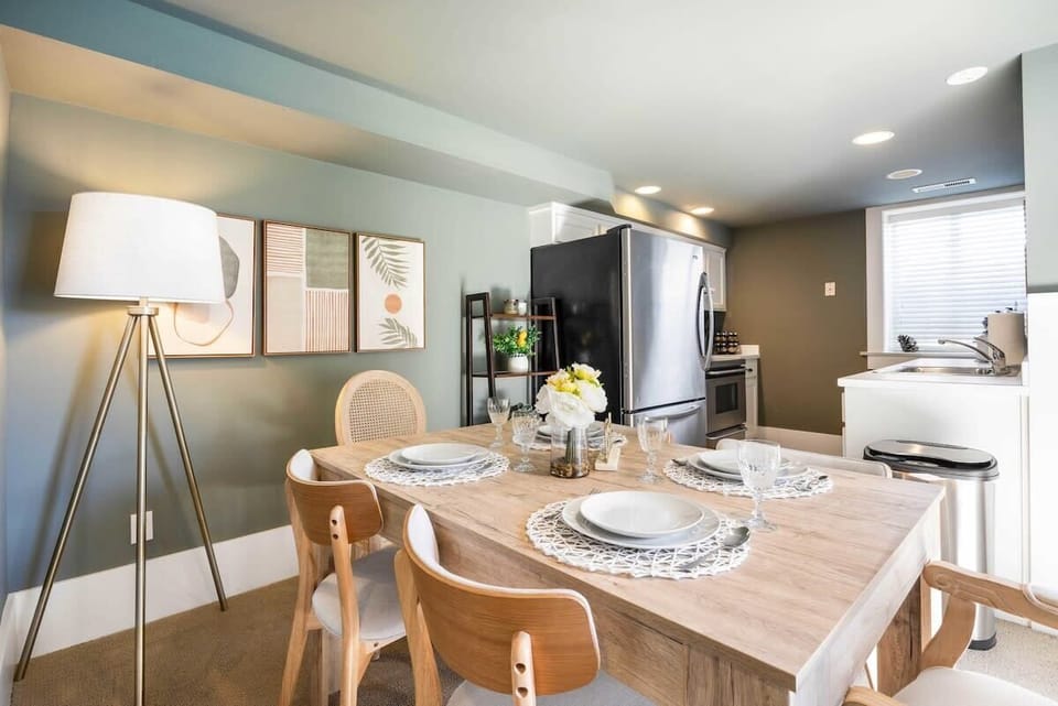A cozy dining table with a well equipped kitchen for you