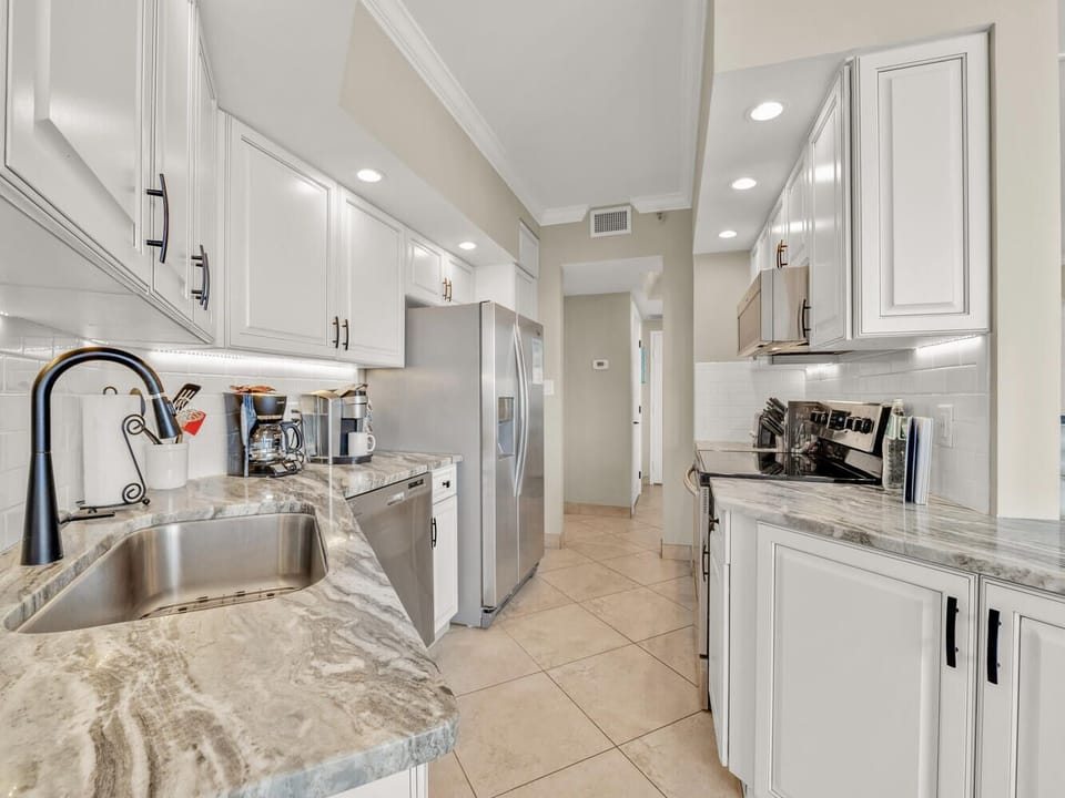 Your fully equipped gourmet kitchen awaits with granite countertops, stainless steel appliances, and everything you need to create memorable meals together.