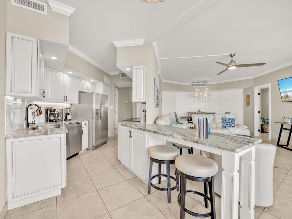 Your spacious open kitchen features granite countertops, stainless steel appliances, and a breakfast bar perfect for morning coffee or casual meals.