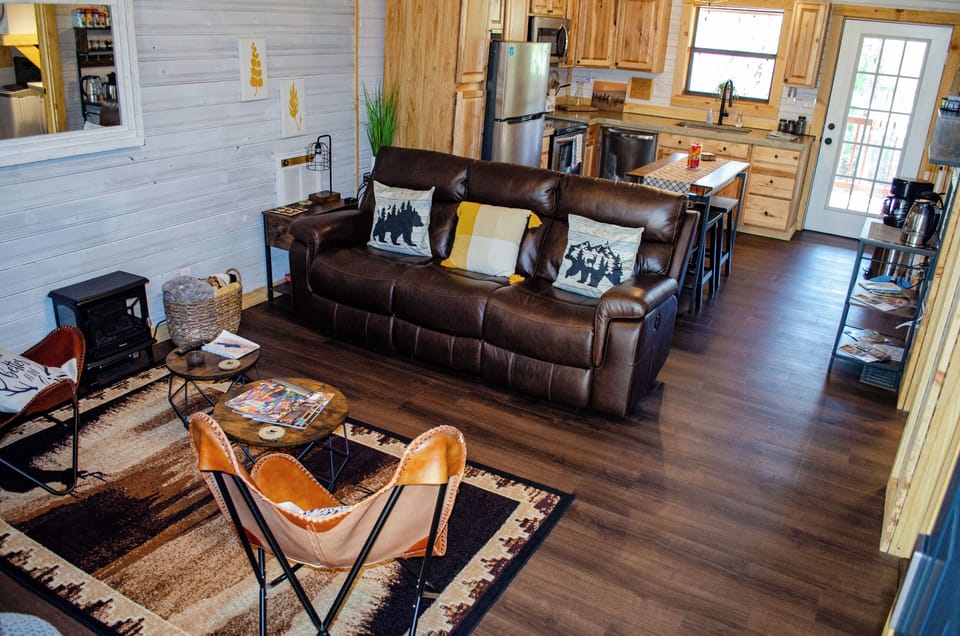 Living room and kitchen.  Leather sofa with dual recliners on both ends 