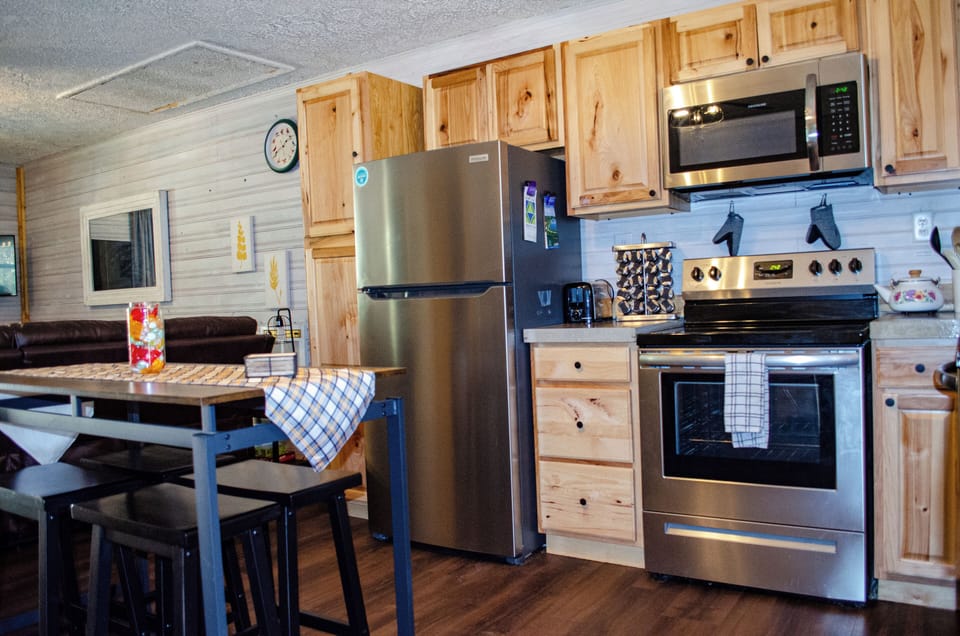 Kitchen with all stainless-steel appliances and concrete countertops