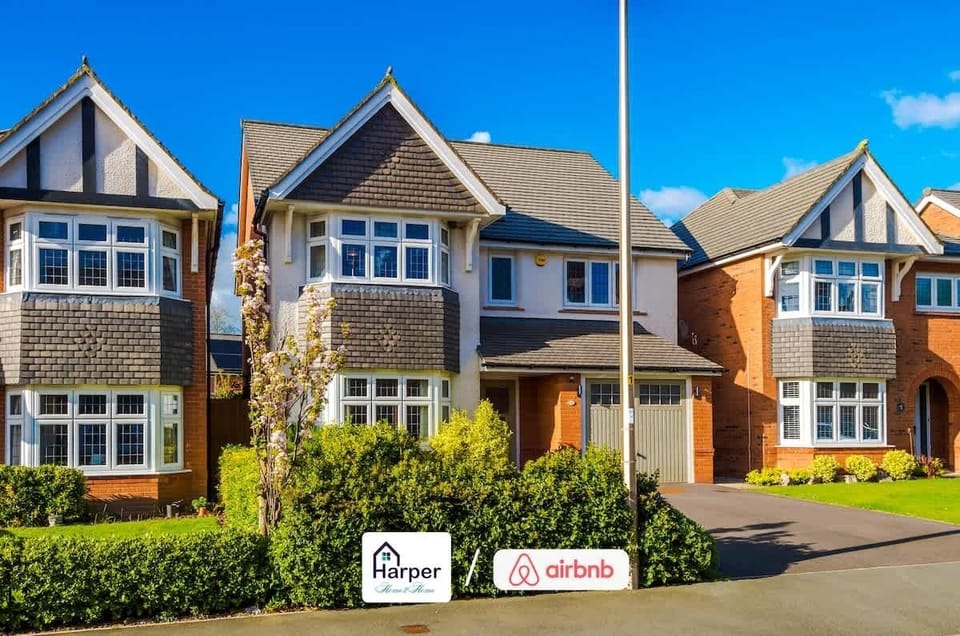 Elegant exterior design with bright brickwork and manicured greenery offering a warm welcome.