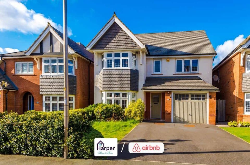 Elegant exterior design with bright brickwork and manicured greenery offering a warm welcome.