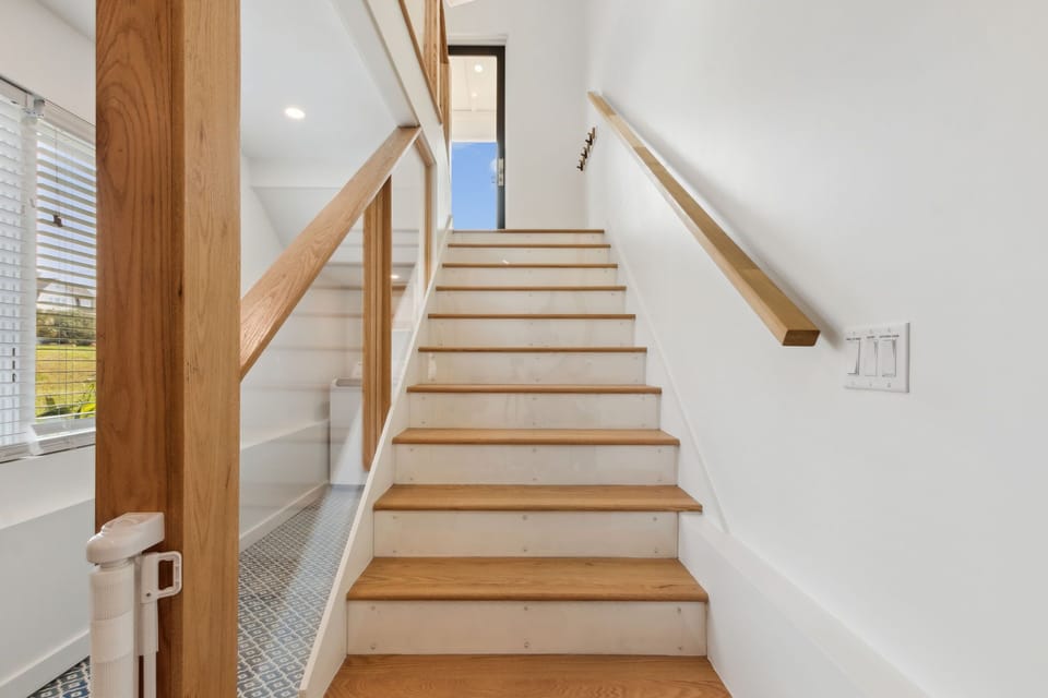 First floor stairs looking up to entry landing.