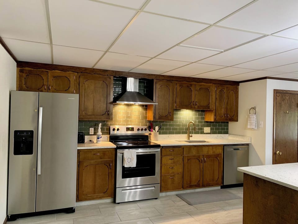 Full kitchen including fridge with water/ice dispenser and dishwasher.