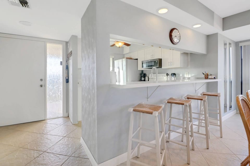 A eating bar with bar stools defines the kitchen space and provides a great spot for a casual bite to eat.