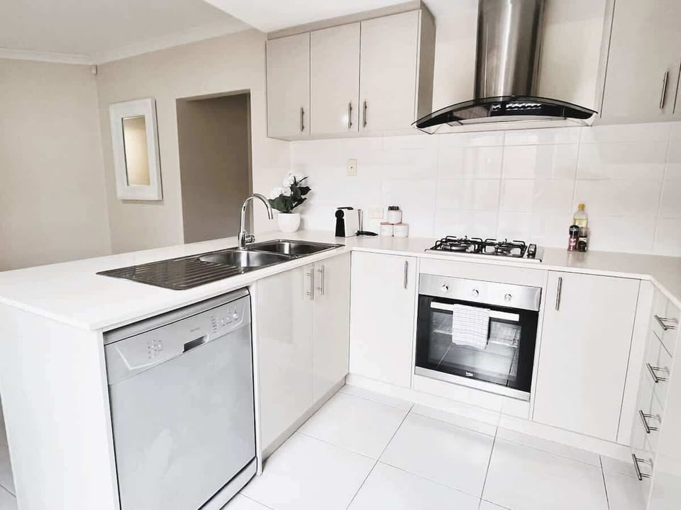 Cook with ease in our well-appointed kitchen featuring a gas stove, oven, and dishwasher. All the essentials for a comfortable stay.