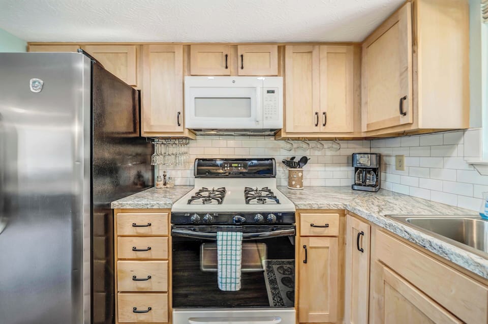 The fully equipped kitchen features granite countertops and a stainless-steel refrigerator and has everything you need to prepare meals for family & friends.