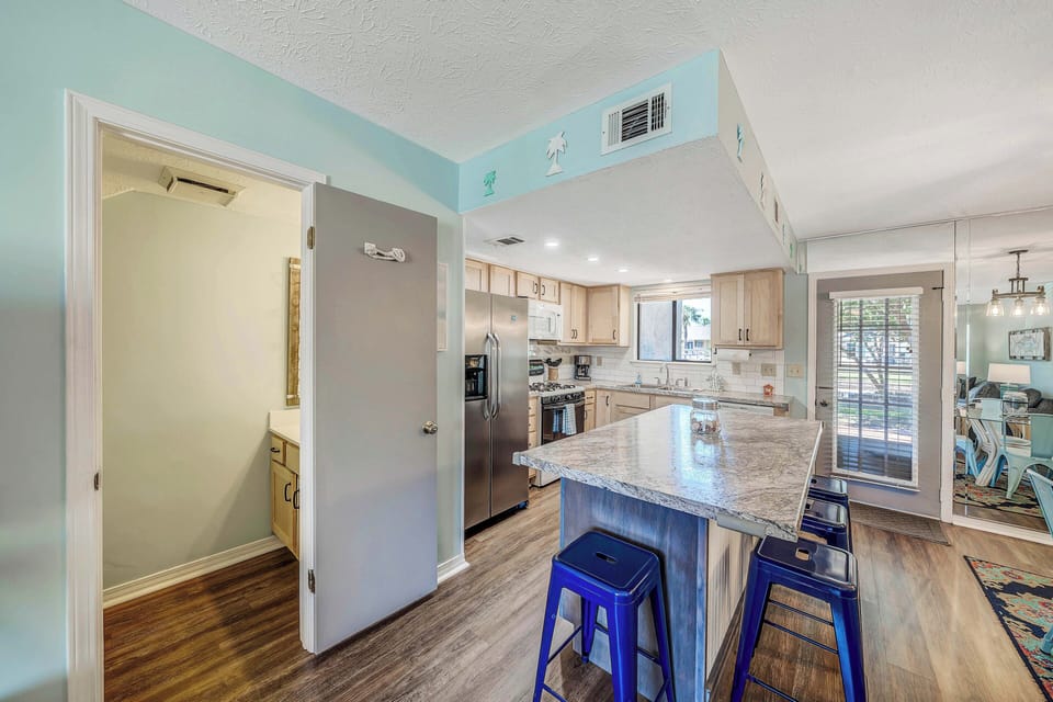 There is a dining table, as well as breakfast bar seating.