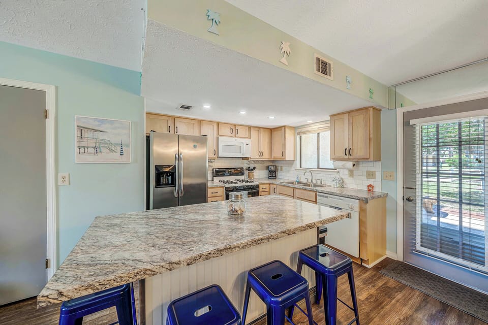 The fully equipped kitchen features granite countertops and a stainless-steel refrigerator and has everything you need to prepare meals for family & friends.
