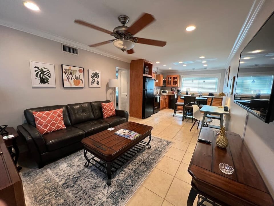 Open plan Living room with dedicated work space and 55 inch Roku smart TV. 