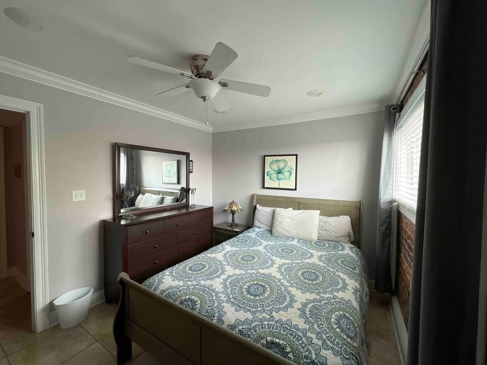 Bedroom 2 has great clothes storage, queen bed, ceiling fan, light blocking shades, and great style.