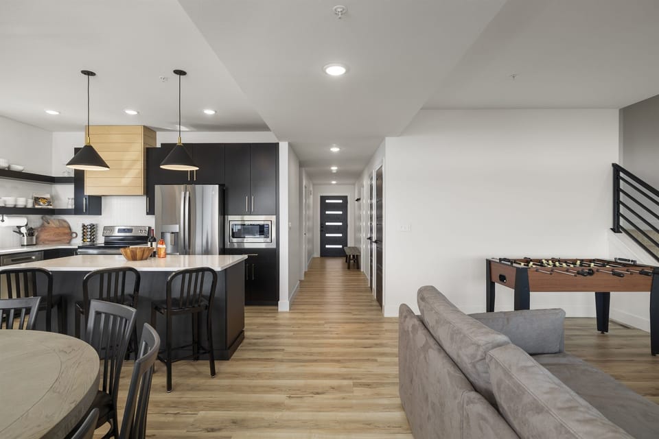 Main Level: Kitchen & Living Room w/ 85" TV, fireplace, and foosball table