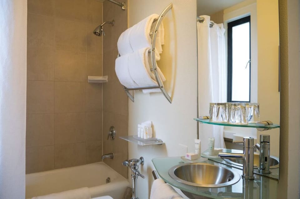 Spacious and modern bathroom in our premium room, featuring high-end fixtures and a bright, clean design.