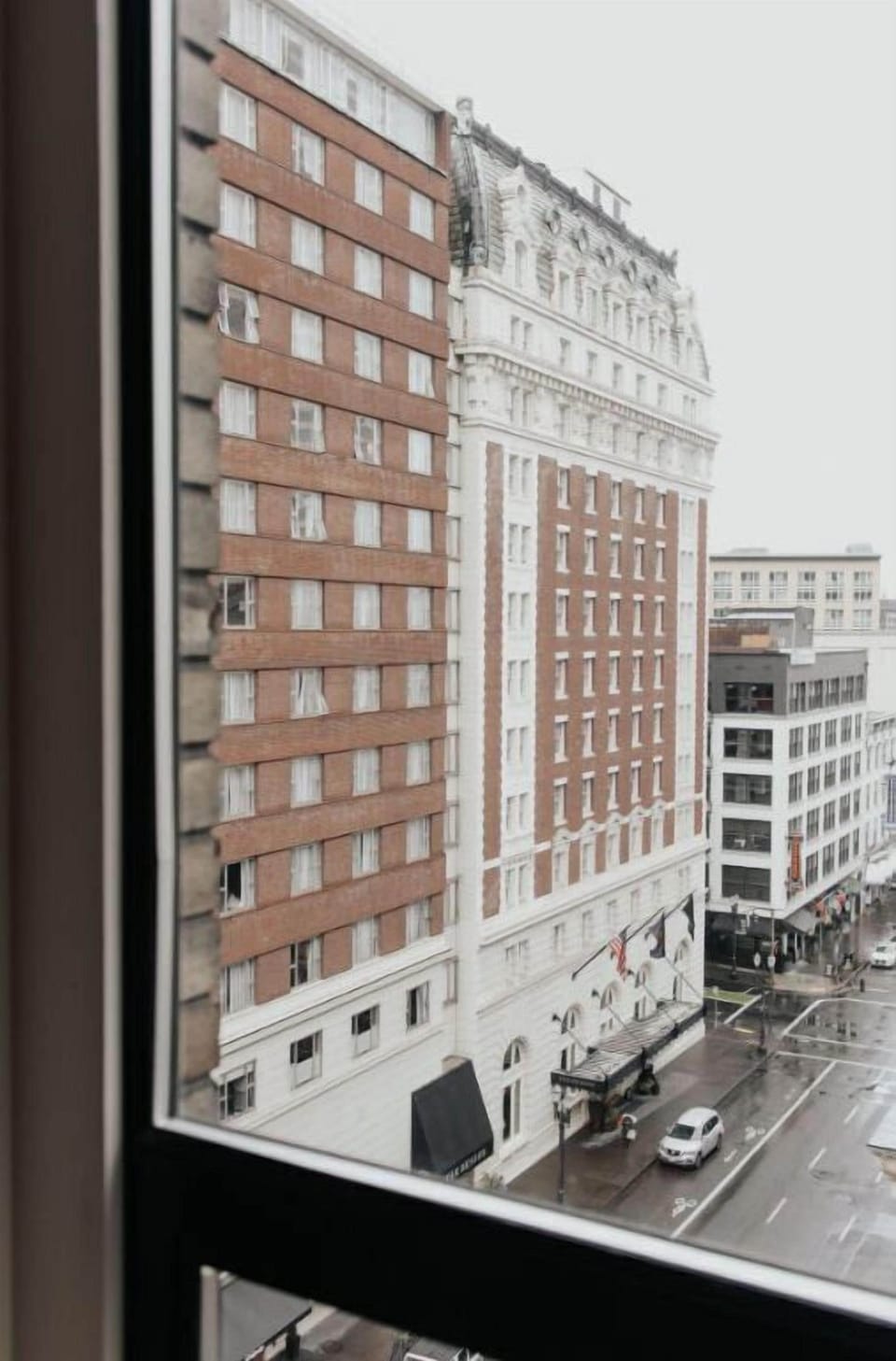 Hotel Lucia seen from a distance, showcasing its prominent place in the city's architectural landscape.