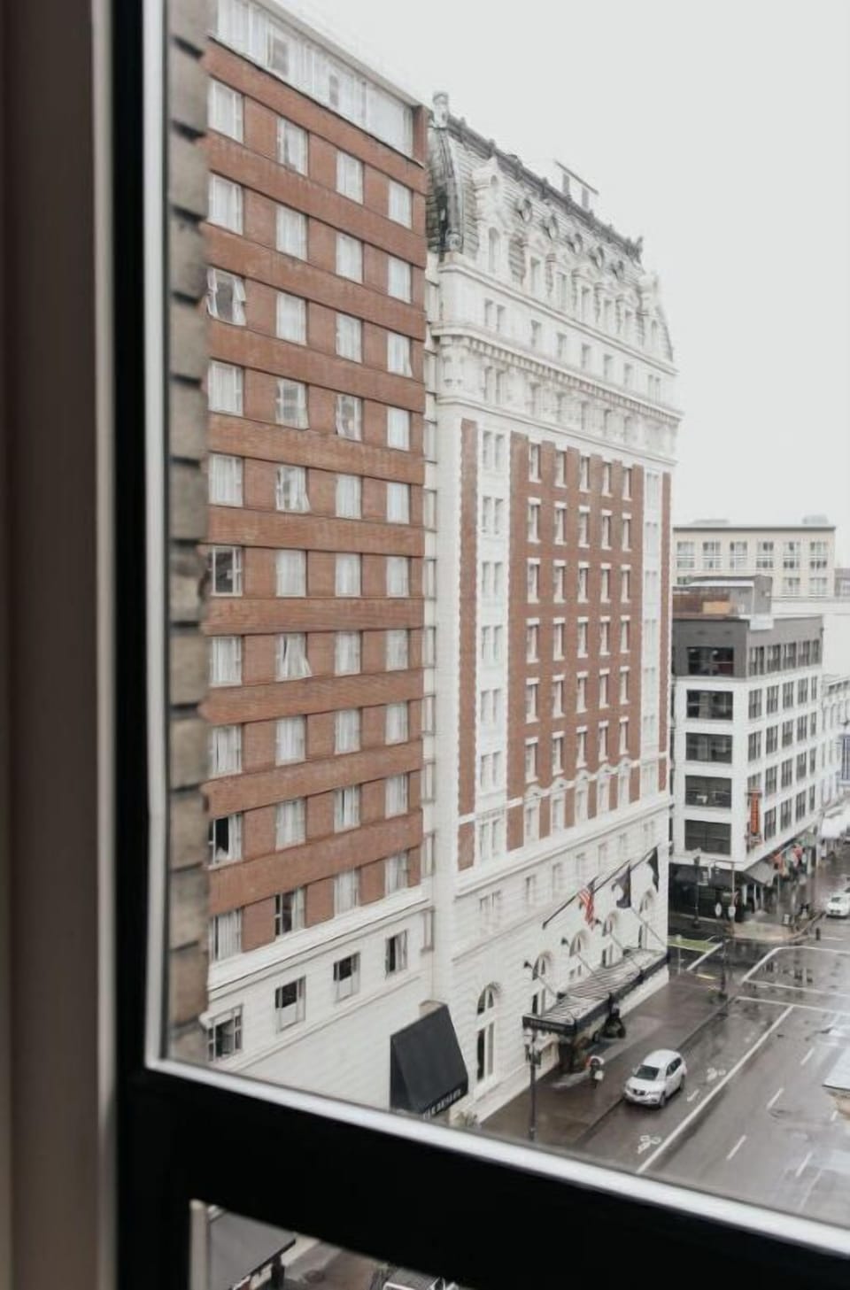 Hotel Lucia seen from a distance, showcasing its prominent place in the city's architectural landscape.