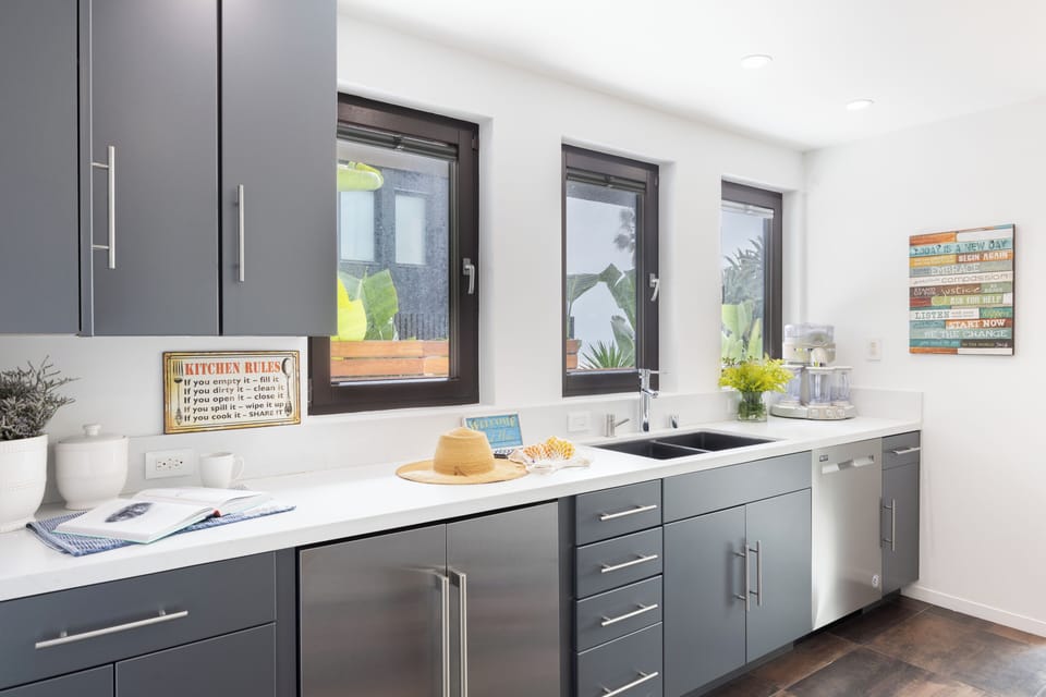 The downstairs kitchenette features a sink, mini refrigerator, and dishwasher.