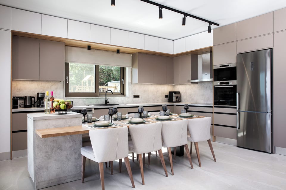 The fully equipped kitchen with all modern appliances, also features a dining table, seating 6 guests