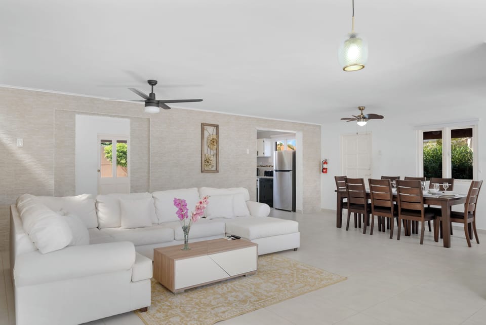 Escape to comfort and style in elegantly furnished living area of the home in Noord Aruba - Beautiful living area with an open layout, creating a sense of spaciousness - Cozy L shape sofa conducive to relaxation and socializing