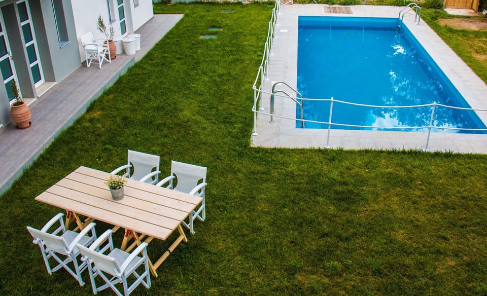 Bird’s-eye view of the property and pool – Shows lawn, pool, and outdoor setup from above.

