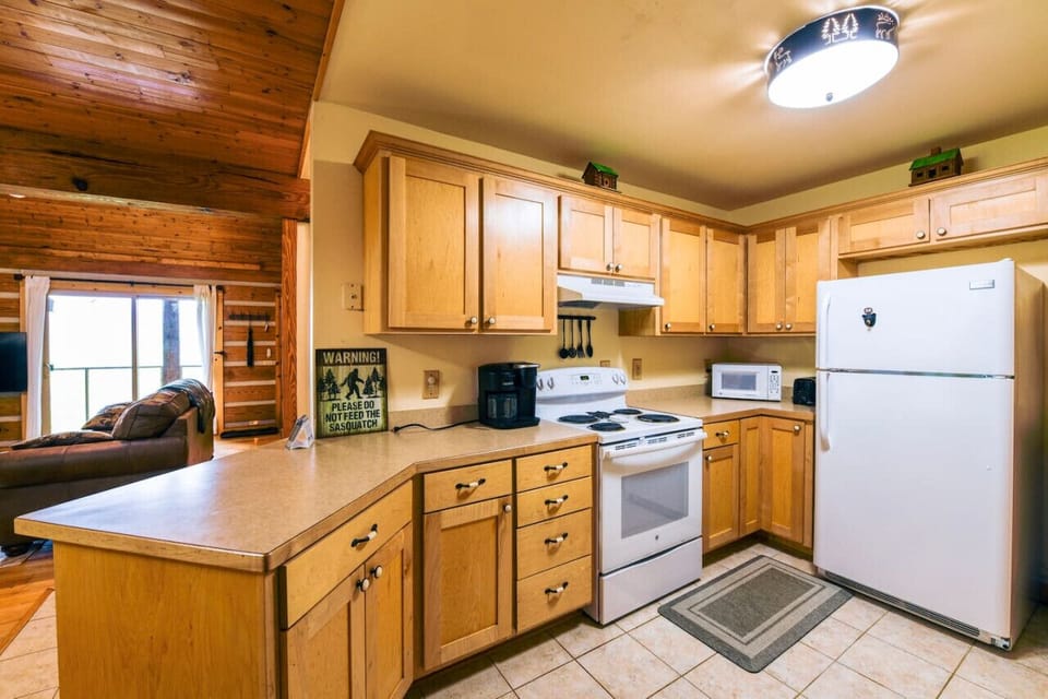 Charming Rustic Kitchen: Warm Cabin Vibes with Modern Convenience.